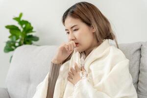 sick woman with a headache sitting under blanket, female sneezing and runny nose with seasonal influenza, allergic, high fever and influenza, resting, virus, coronavirus, feel illness, respiratory photo