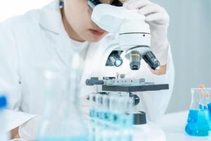 Scientist analyze biochemical samples in advanced scientific laboratory. Medical professional use microscope look microbiological developmental of viral. Biotechnology research in science lab. photo