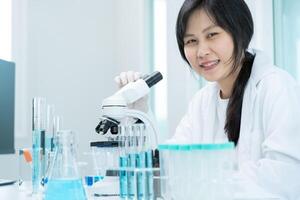 analyze biochemical samples in advanced scientific laboratory. Medical professional use microscope look microbiological developmental of viral. Biotechnology research in science lab. photo