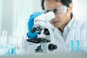 Scientist analyze biochemical samples in advanced scientific laboratory. Medical professional use microscope look microbiological developmental of viral. Biotechnology research in science lab. photo