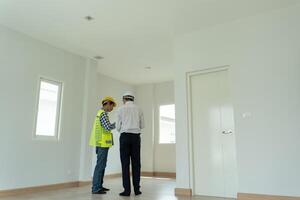 inspector engineer and owner project is inspecting construction and quality assurance new house. Engineers or architects or contactor work to build the house before handing it over to the homeowner photo