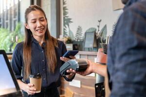 Woman use smartphone to scan QR code to pay in cafe restaurant with a digital payment without cash. Choose menu and order accumulate discount. E wallet, technology, pay online, credit card, bank app. photo