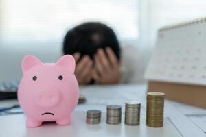 Stressed and headache man with large bills or invoices no money to pay to expenses and credit card debt. shortage, Financial problem, bankruptcy, mortgage, loan, bankrupt, poor, empty wallet photo