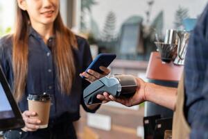 Woman use smartphone to scan QR code to pay in cafe restaurant with a digital payment without cash. Choose menu and order accumulate discount. E wallet, technology, pay online, credit card, bank app. photo