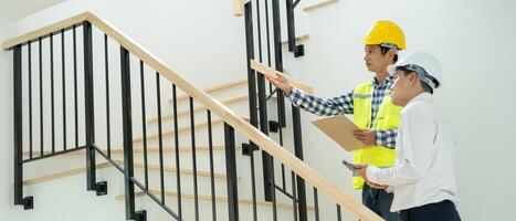 inspector or engineer is inspecting construction and quality assurance new house using a checklist. Engineers or architects or contactor work to build the house before handing it over to the homeowner photo