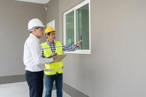 inspector engineer and owner project is inspecting construction and quality assurance new house. Engineers or architects or contactor work to build the house before handing it over to the homeowner photo