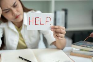 Asian student woman have anxiety because of exams, female prepare for test and learning lessons in the library. stress, despair, haste, misunderstanding reading, discouraged, expectation, knowledge photo