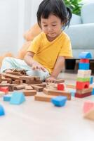 Happy Asian child playing and learning toy blocks. children are very happy and excited at home. child have a great time playing, activities, development, attention deficit hyperactivity disorder photo