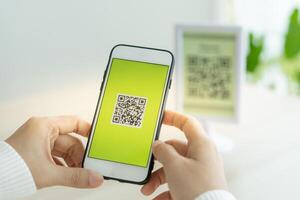 Woman use smartphone to scan QR code for order menu in cafe restaurant with a digital delivery. Choose menu and order accumulate discount. E wallet, technology, pay online, credit card, bank app photo