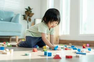 Happy Asian child playing and learning toy blocks. children are very happy and excited at home. child have a great time playing, activities, development, attention deficit hyperactivity disorder photo