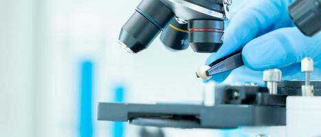 Scientist analyze biochemical samples in advanced scientific laboratory. Medical professional use microscope look microbiological developmental of viral. Biotechnology research in science lab. photo
