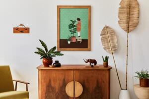 Minimalist composition of living room with brown mock up picture frame, retro armchair, dried tropical leaf, decoration and elegant personal accessories in stylish home decor. Template. photo