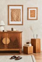 Interior design of living room with stylish retro commode, mock up poster frame, cube, table lamp, decoration and elegant personal accessories in home decor. Template. Japandi concept. photo