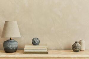 Stylish minimalistic monochromatic composition with design vases, elegant lamp and personal accessories. Copy space. Neutral colors. photo