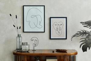 Stylish minimalistic composiotion of creative living room interior with two mock up poster frames, wooden commode, dry flowers in glass vases and elegant personal accessories. Template. photo