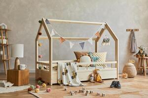 Creative composition of cozy scandinavian child's room interior with wooden furniture, plush and wooden toys and textile hanging decorations. Neutral creative wall, carpet on the floor. Template. photo