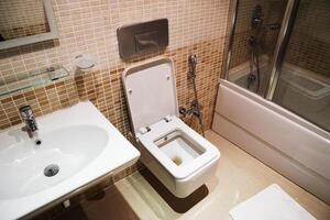 White modern ceramic sinks and toilet in the bathroom. photo