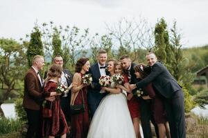 A group of people, including a bride and groom, are posing for a photo