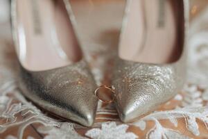 A pair of high heels with a ring on the toe photo