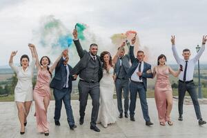A group of people are posing for a photo, with some of them holding smoke bombs photo