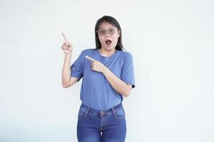 Beautiful Asian woman looks shocked, with a 'wow' expression, pointing to the side with her forefinger photo