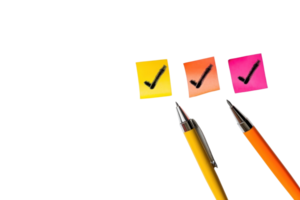 Colorful sticky notes with check marks, next to pencils. Concept of organization, planning, and task management. png