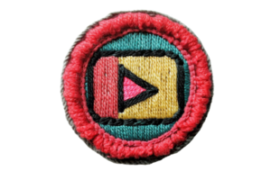 Colorful embroidered badge in circular shape with play button in the center. Ideal for scouts, patches, crafting, or decoration. png
