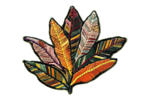 Colorful embroidered fabric leaf design with intricate patterns, perfect for crafts, fashion, or home decor projects. png