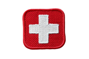 Red and white embroidered Swiss flag patch, isolated on transparent background. ideal for travel, fashion, and memorabilia collections. png
