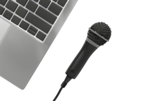 Close-up of a microphone placed next to a laptop, symbolizing technology and communication in digital and audio recording setups. png