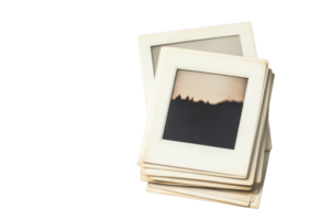 Stack of vintage photo slides with faded landscape image, isolated on blank background, ideal for nostalgic or retro themes. png