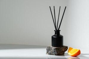 Aromatic Reed Diffuser on a Stone Base With Orange Slice Accent photo