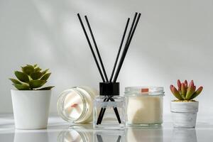 Elegant Home Fragrance Reed Diffuser Displayed Beside Scented Candles and Succulents photo