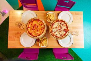 Freshly Baked Pizzas Served on Wooden Stands at an Outdoor Party Setting photo