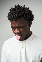 Man Sticking Out Tongue and Making Funny Face photo