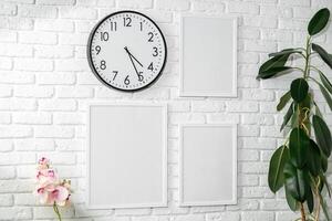 Minimalist White Wall Display With Clock and Empty Frames in a Modern Interior photo