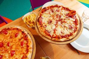 Freshly Baked Pizzas Served on Wooden Stands at an Outdoor Party Setting photo