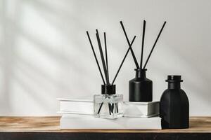 Aromatic Reed Diffuser on White Books With Shadows Playing on the Wall photo