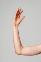 Close-Up of a Human Arm Extended Against a Plain Background photo
