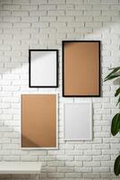 Varied Sized Photo Frames Displayed on a White Brick Wall