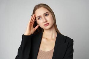 Woman Posing With Hands on Face against gray background photo