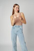 Young Woman Pointing Towards Camera With a Playful Expression in a Studio photo