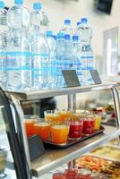 Colorful Array of Fruit Juice Cups on a Serving Cart in a Cafeteria photo