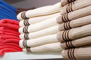 Stack of Neatly Folded White Towels on a Retail Store Shelf photo