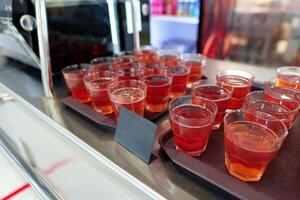 Colorful Array of Fruit Juice Cups on a Serving Cart in a Cafeteria photo