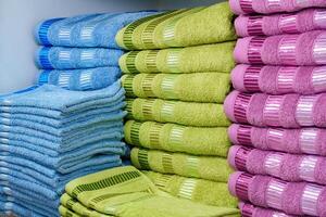 Stack of Neatly Folded White Towels on a Retail Store Shelf photo