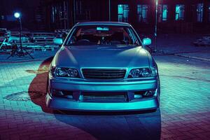 Silver Car Parked in Front of Building photo