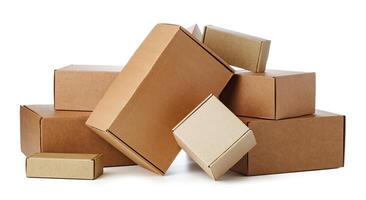 Stacked brown cardboard boxes in various sizes arranged on a white background photo