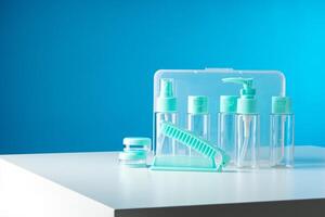 Clear containers for beauty products arranged on a white surface against a bright blue background photo