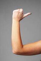 signaling a small size against a gray background photo